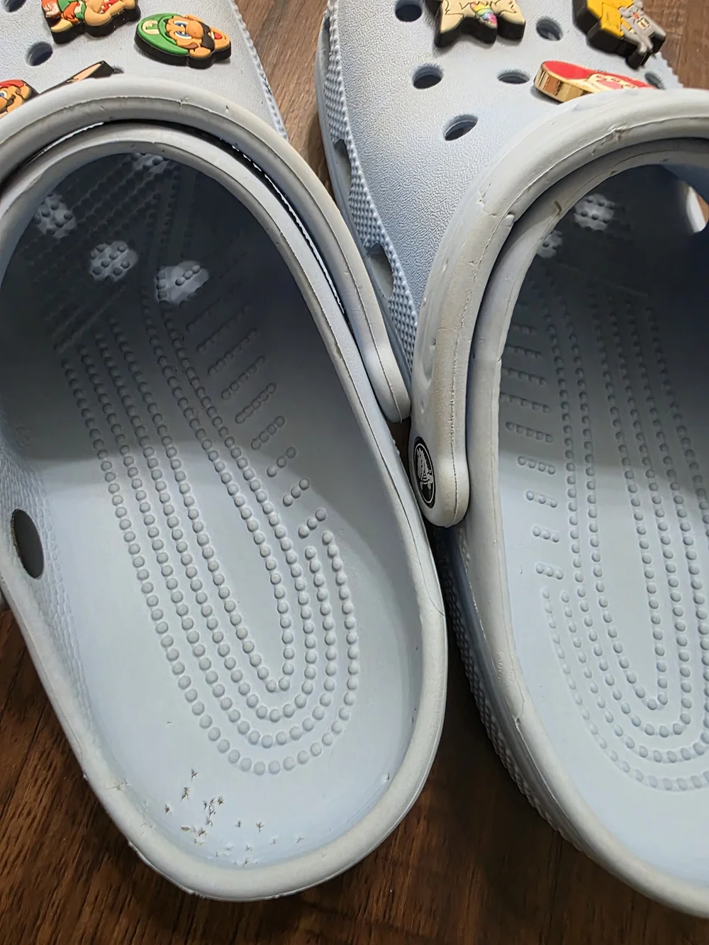 Crocs Classic Clog in a light blue color, size M6 / W8. Includes assorted decora